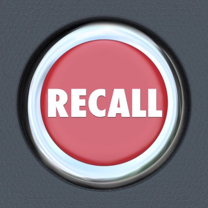 Recall word on a red round car or vehicle ignition button to ill